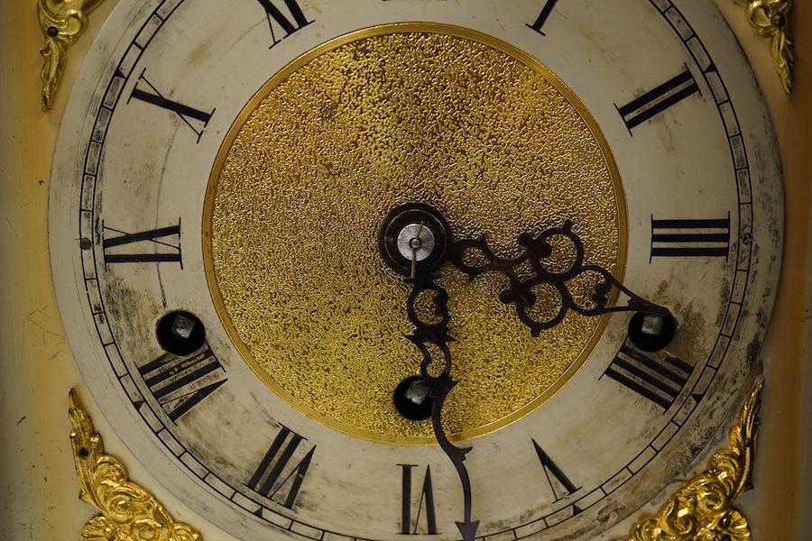 An Edwardian three train mahogany bracket clock and bracket, chiming on four coiled gongs, clock 42.5cm high. Condition - good